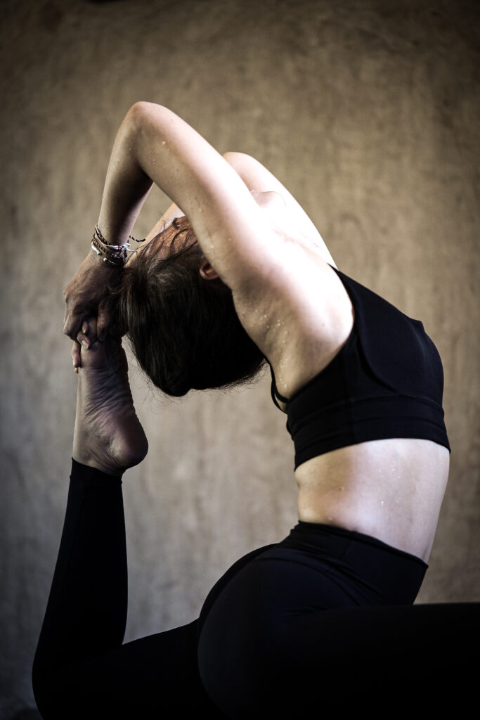 Women Yoga pose back bend heart opener in yogateacher training