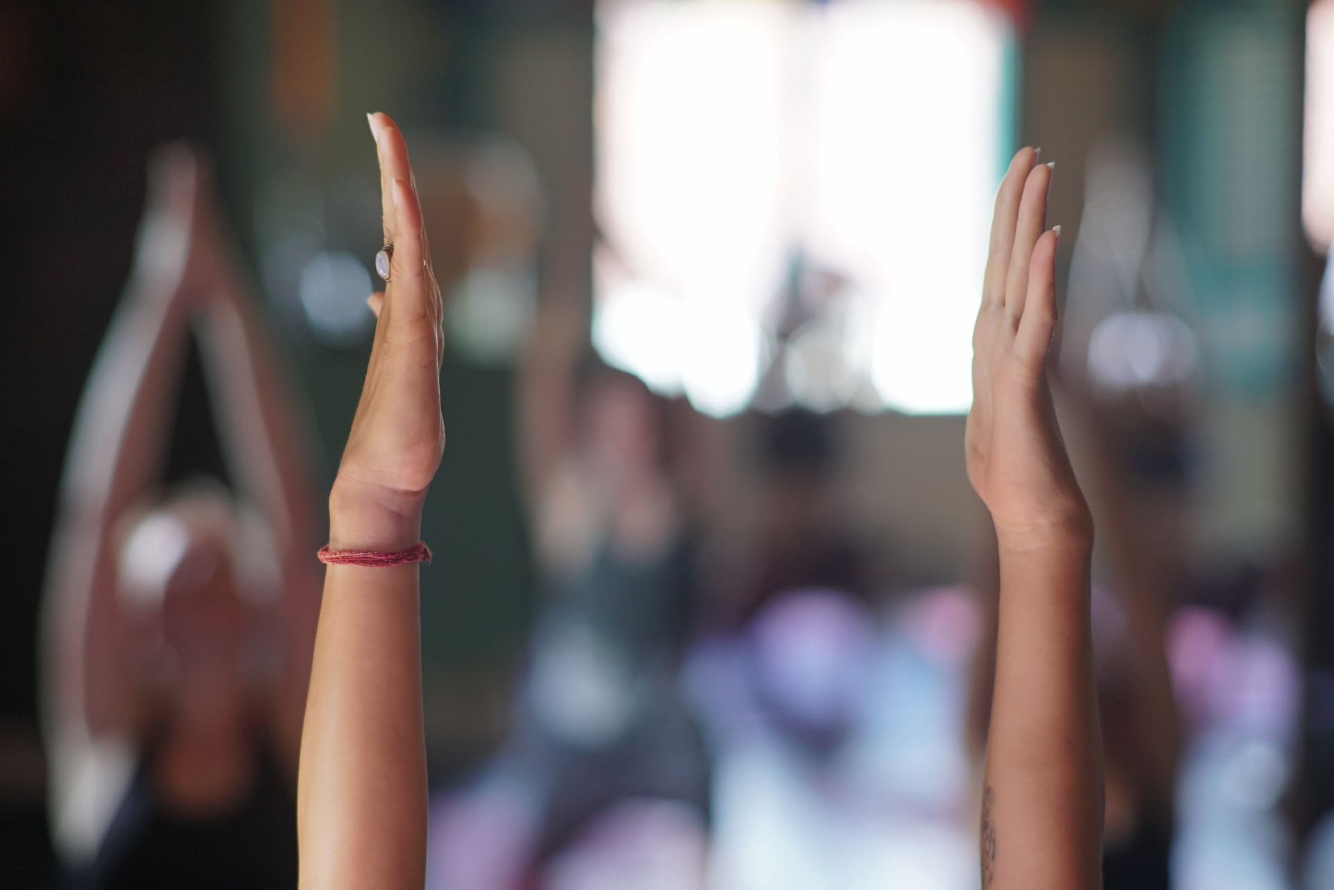 Hands in the air in yoga high crescent pose