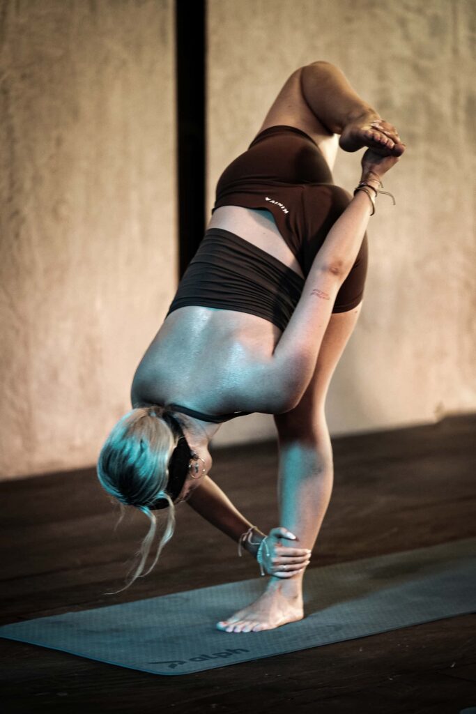Woman in balance yoga pose at Studio 108 Seminyak Bali