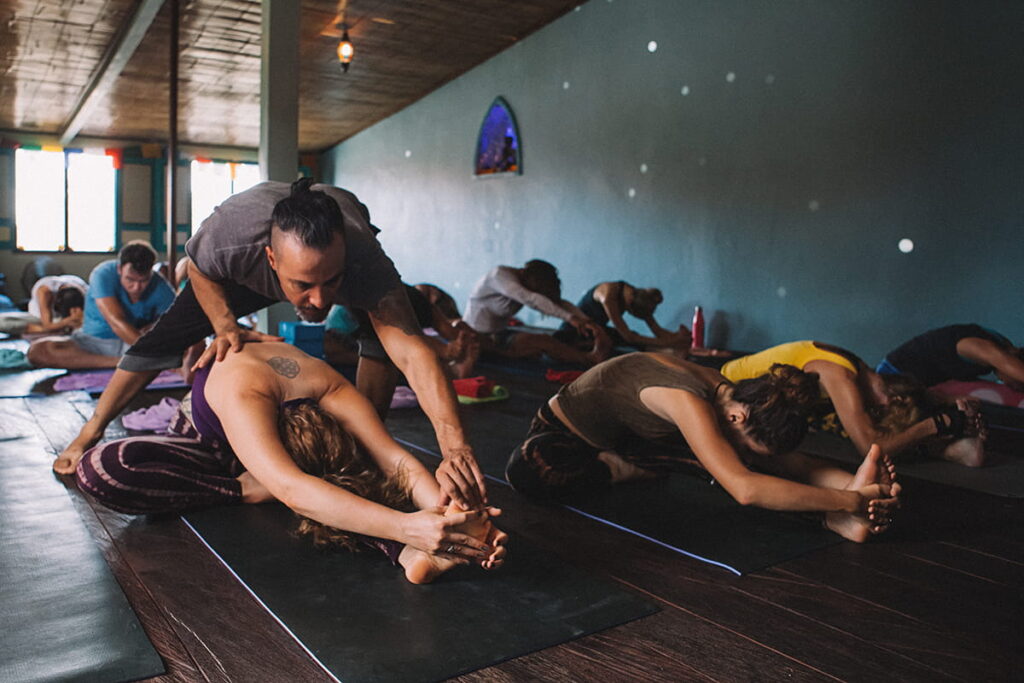Yoga workshop hands on adjustment by teacher